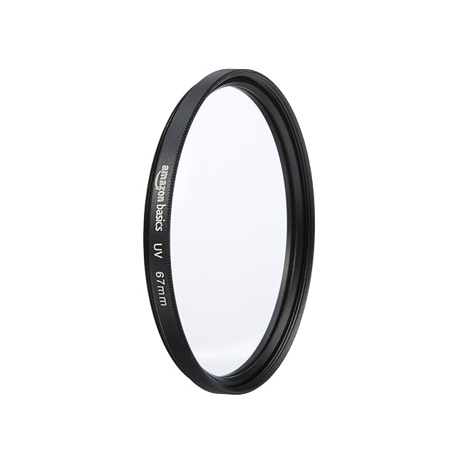 Filtro UV Amazon Basics da 67 mm appoggiato piatto su un tappo per obiettivo